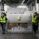 UPS employees move one of two shipping containers containing the first shipments of the Pfizer and BioNTech COVID-19 vaccine inside a sorting facility at UPS Worldport on December 13, 2020 in Louisville, Kentucky.